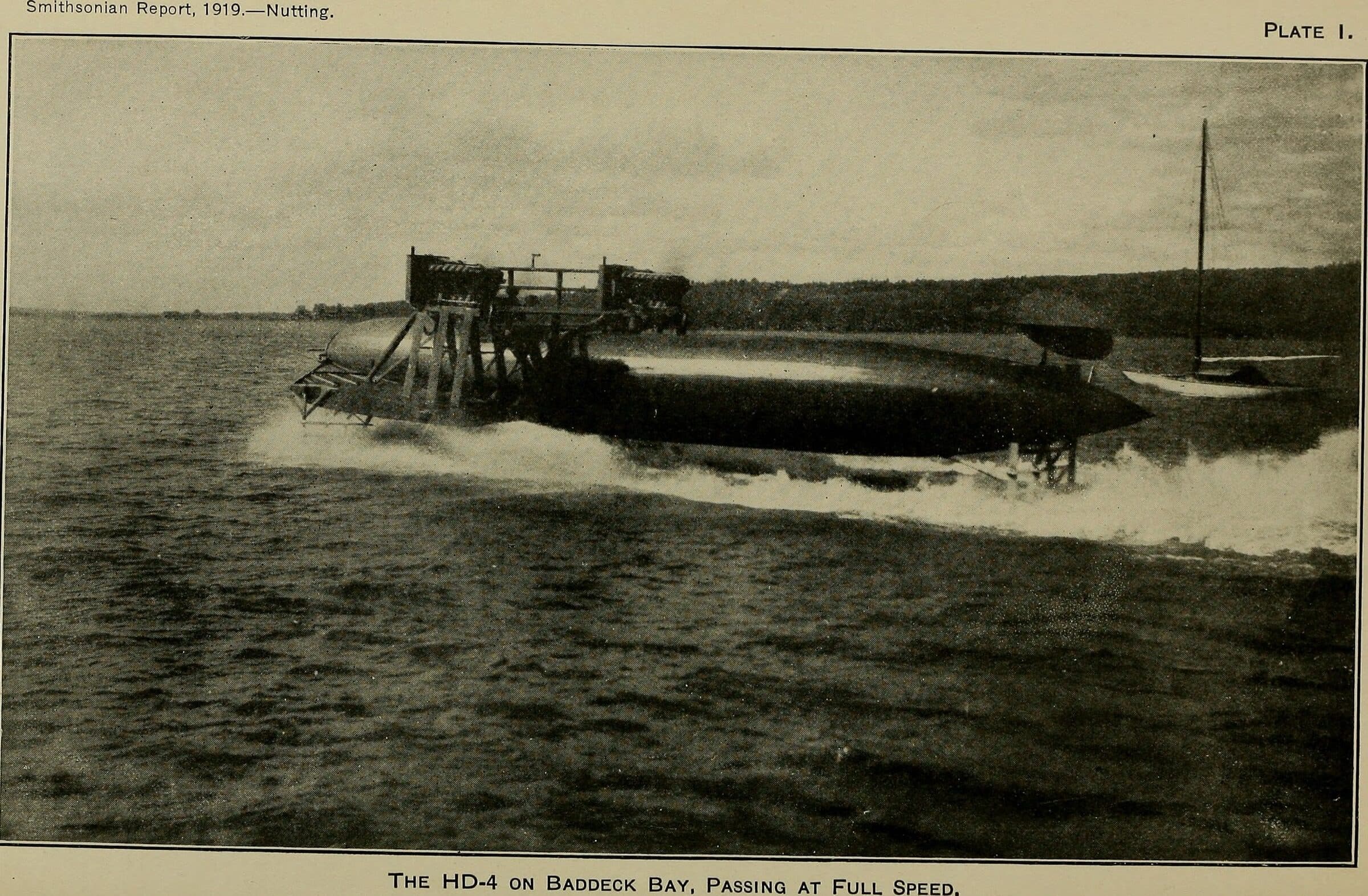 The HD-4 on Baddeck Bay, passing at full speed (Smithsonian Report 1919, plate 1): Bell–Baldwin HD-4 hydrofoil, three-quarter side view, running at speed with the cigar hull clear of the water and spray from the foils; book plate with printed caption. Craft fills the centre.